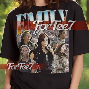 May include: Black unisex t-shirt with a graphic print of a group of women with the text "Emily For Tee7" on the front. The model is wearing a size XL.