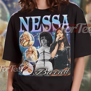 May include: Black unisex t-shirt featuring a graphic of Nessa Barrett with her name in a stylized font. The design includes multiple images of the singer. The shirt has the text "UNISEX SHIRT" at the top.