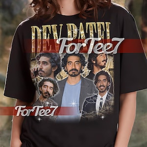 May include: Black unisex t-shirt with a gold graphic print of Dev Patel's face and the text "Dev Patel For Tee7".