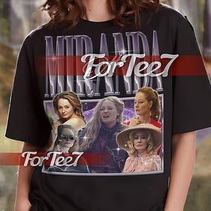 May include: Black unisex t-shirt with a graphic print of a collage of images of women. The text "Miranda For Tee7" is printed on the shirt.