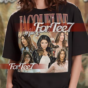 May include: Black unisex t-shirt with a graphic print of a group of women with the text "JACOLINE For Tee7" in gold lettering.