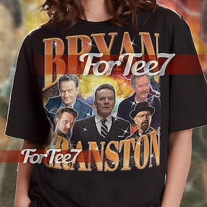 May include: Black unisex shirt featuring a graphic of Bryan Cranston and the text "BRYAN CRANSTON For Tee7". The shirt includes the text "UNISEX SHIRT". The model is wearing an XL shirt. Refer to the size chart for accurate sizing.