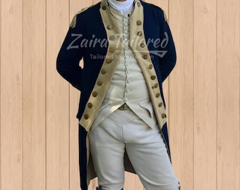 May include: A navy blue and tan historical costume with gold buttons. The costume includes a long coat, vest, and pants. The text "Zaira Tailored" is visible in the image.