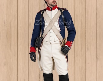 May include: A historical military uniform featuring a dark blue coat with red cuffs and collar, white trousers, and a black shako hat with a gold emblem. The ensemble includes white cross-belts, black leather gloves, and tall black boots.