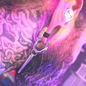 May include: A white ceramic mug with a black handle and the text "But First, Coffee" in a handwritten style. The mug is on a white surface. The mug is approximately 4 inches tall.