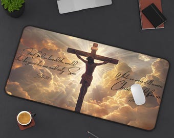 May include: A Christian-themed mouse mat featuring a depiction of Jesus Christ on the cross against a backdrop of clouds. The text reads "For God so loved the world that he gave his one and only Son" and "While we were still sinners, Christ died for us."
