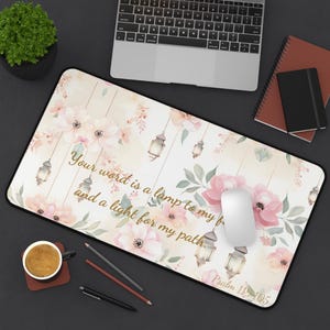 May include: A white desk mat with a floral design and a gold quote that reads "Your word is a lamp to my feet and a light for my path. Psalm 119:105".