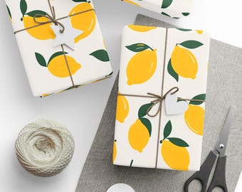 May include: Gift-wrapped boxes with a lemon pattern, tied with twine and adorned with white star-shaped tags. A spool of twine, scissors, and blank tags are also present, suggesting a theme of gift-giving and crafting.