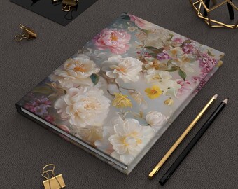 May include: A hardcover journal with a floral design featuring white, pink, and purple flowers on a gray background.
