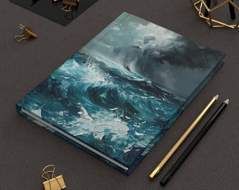 May include: Hardcover journal featuring an ocean wave painting in shades of teal, blue, and white. The artwork depicts a stormy sea with a small boat. Gold and black pencils and gold binder clips are also visible.