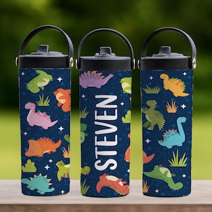 May include: Three insulated water bottles with black handles and lids. The bottles are navy blue and covered in colorful dinosaur illustrations and white stars. One bottle has the name "STEVEN" in white. The bottles are on a wooden surface.