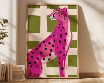May include: A framed wall art print featuring a vibrant pink cheetah with black spots standing in profile. The background consists of a grid pattern with alternating olive green squares and off-white cream colored squares.