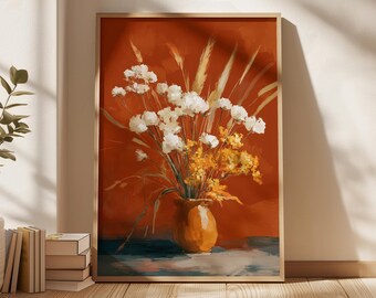 Puede incluir: Una impresión artística enmarcada que presenta un bodegón floral. La obra muestra un jarrón lleno de flores blancas y amarillas y hierbas secas, sobre un fondo naranja quemado. El jarrón es de un cálido color naranja.