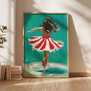 May include: A framed art print of a dancer in a red and white striped dress, viewed from the back. The dancer is set against a teal background. The artwork is in a wooden frame and is displayed on a wooden floor.