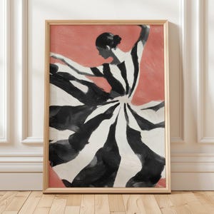 May include: A framed art print of a dancer in a black and white striped dress, set against a coral background. The dancer's silhouette is captured mid-motion, with arms outstretched. The artwork is in a wooden frame.