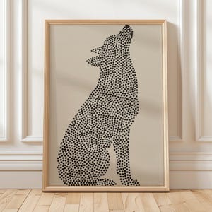 May include: Framed art print showing a black and white illustration of a howling wolf. The wolf's silhouette is made up of small black dots on a beige background. The artwork is in a light brown wooden frame.