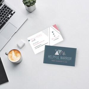 May include: Two business cards with a pink and white design and a blue and white design. The pink and white card has the text "Molly Pierce coach" and the blue and white card has the text "Helpful Warrior".