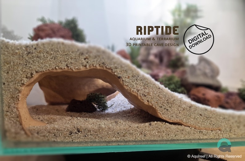 3D printed Riptide Aquarium Cave STL file in a sandy aquarium setup with rocks, moss, and plants, showcasing its natural design and functionality for fish, shrimp or reptiles. Digital download only, STL design for 3d print.