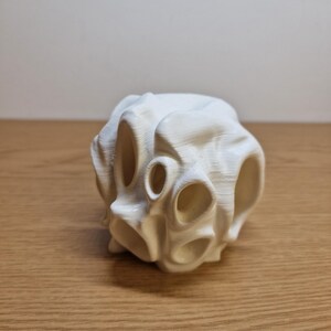 3D-printed white aquarium cave with multiple openings, designed for fish hiding, playing, and exploration. Its smooth, organic design enhances aquarium aesthetics while providing shelter and reducing fish stress in aquatic environments.