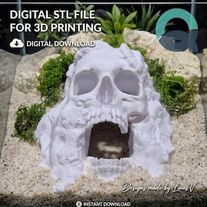 May include: A white 3D printed skull-shaped cave structure with a hollow interior, featuring text that reads DIGITAL STL FILE FOR 3D PRINTING, DIGITAL DOWNLOAD, and INSTANT DOWNLOAD. The skull is surrounded by green moss and light-coloured rocks.