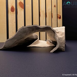 Side view of the Riptide Aquarium Cave STL file on a flat surface, emphasizing its textured design, dual entrances, and durability. Ideal for 3D printing to create aquatic or terrarium decorations.