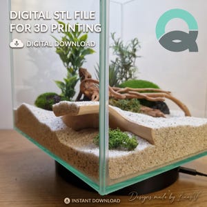 May include: A digital STL file for 3D printing featuring a terrarium design with a light-colored bridge, white sand, green moss, and driftwood inside a square glass container. The text reads DIGITAL STL FILE FOR 3D PRINTING and DIGITAL DOWNLOAD.