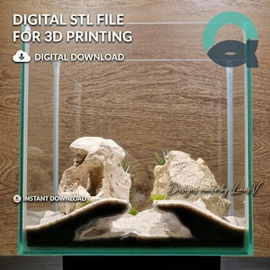 May include: A clear glass aquarium tank containing a 3D printed structure with two large, textured, beige rock-like formations resting on a bed of light-coloured sand. The text DIGITAL STL FILE FOR 3D PRINTING and INSTANT DOWNLOAD is visible.