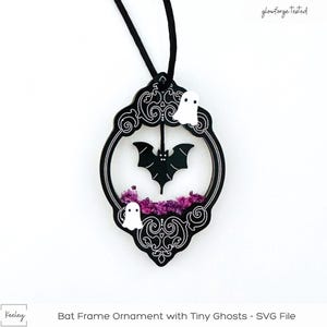 May include: Black and white bat frame ornament with tiny ghosts and purple glitter. The ornament is hanging from a black cord. "glowforge tested" is written in the top right corner of the image. "Bat Frame Ornament with Tiny Ghosts - SVG File" is written at the bottom of the image.