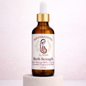 May include: A brown glass bottle with a gold cap and white dropper, labeled "Birth Strength" by Bekah. The label features a pregnant woman illustration and text describing the product as labor massage oil, 2 fl oz.