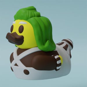 May include: A yellow rubber duck with a green mohawk, brown mustache, and white overalls. The duck is wearing a brown and white striped sleeve.