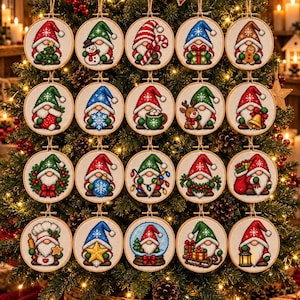 May include: A collection of twenty circular embroidery hoop ornaments featuring cross-stitched gnomes in various holiday-themed poses, including holding Christmas trees, gifts, candy canes, gingerbread men, reindeer, lanterns, and wreaths on white fabric.