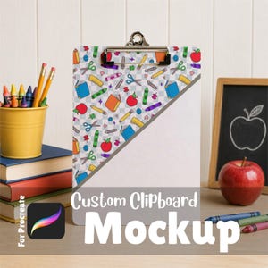 May include: A clipboard featuring a pattern of colorful school supplies like books, scissors, crayons, and apples on a light gray grid background. The clipboard has a metal clip at the top and a diagonal white space across the lower right corner.