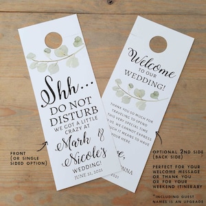 May include: A white door hanger with a green leafy design and the text "Shh... Do Not Disturb We Got A Little Crazy At Mark & Nicole's Wedding! June 21, 2021". The back side of the door hanger has the text "Welcome To Our Wedding! Thank You So Much For Traveling To Spend This Very Special Time With Us. We Cannot Express How Much It Means To Have You Here."