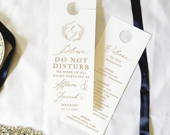 May include: Two ivory door hangers with gold text. One reads "Please Do Not Disturb" with wedding details. The other says "Welcome to our Wedding!" with a schedule. A navy blue ribbon and a jeweled headband are also in the image.