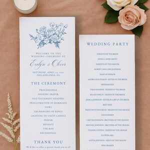 May include: Wedding ceremony program with blue floral design and text. The program includes the couple's names, date, and location. A list of the wedding party is also included. A candle and flowers are in the background.