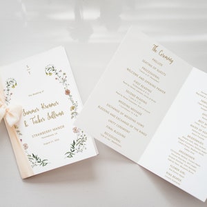 May include: A wedding ceremony program with a floral design on the front cover. The program lists the order of events for the ceremony and the wedding party.