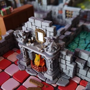 May include: A miniature fireplace with a stone facade, featuring a small fire, a mirror, and two gargoyle statues. The fireplace is part of a larger miniature castle or dungeon set.