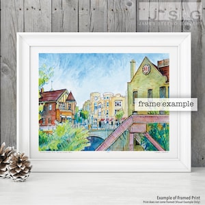 May include: Watercolor painting of a city scene with a bridge over a canal. The buildings are in a variety of colors, including red, yellow, and green. The sky is blue with white clouds. The painting is titled "Something Old, Something New".