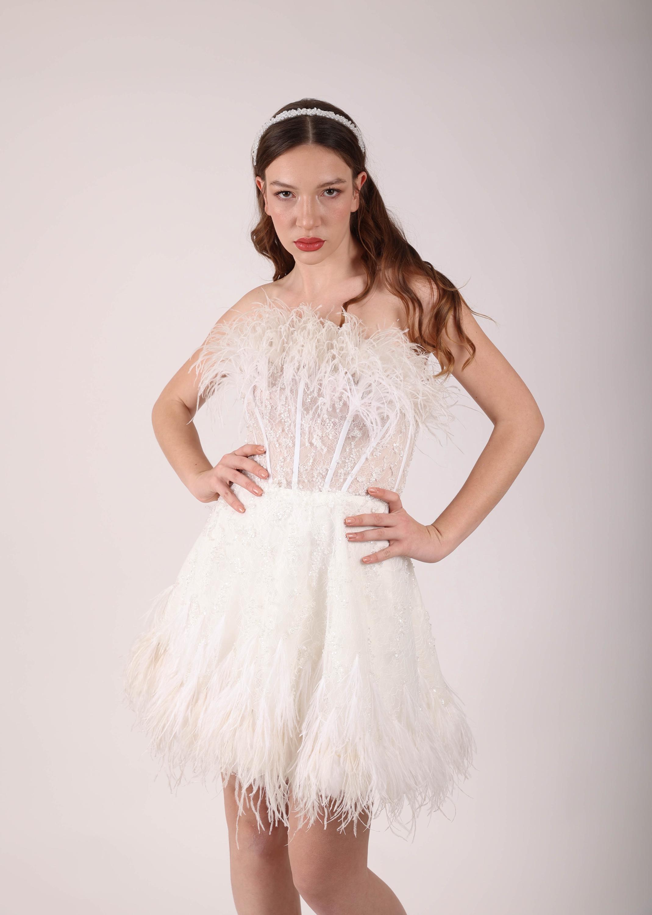 short ostrich feather wedding dress Designed by @NicoleFeliciaCouture exclusively for Kleinfeld, the #GiselleGown is a minimalist strapless fit and flare wedding dress with a front high slit. The optional - and overwhelmingly chic