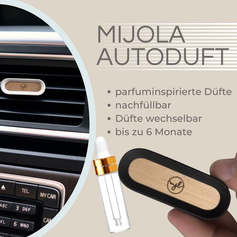 May include: Car air freshener with the text "MIJOLA AUTODUFT". The product is shown in a car's air vent and held in a hand. The air freshener has a wooden and black design. A small bottle with a dropper is also visible.