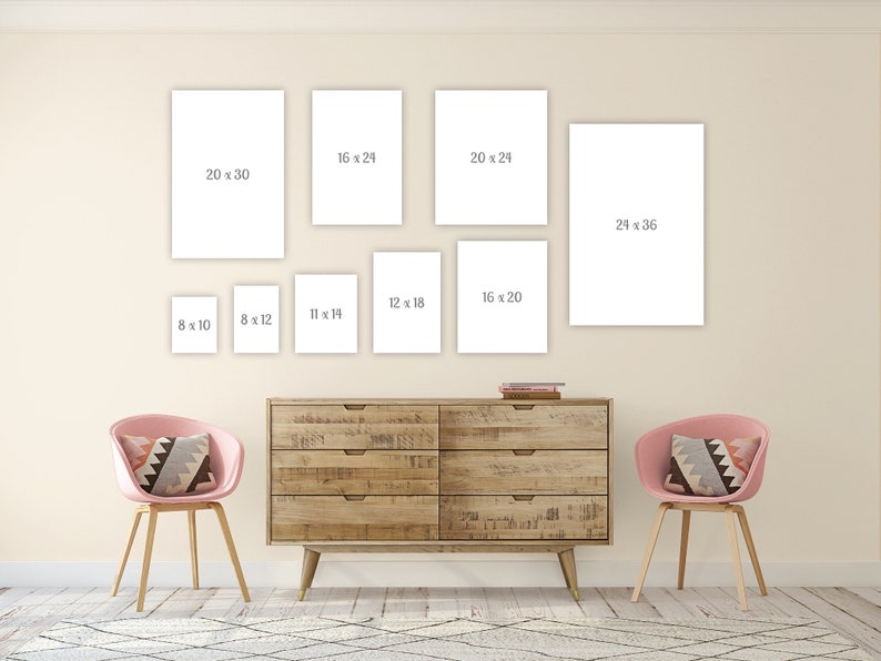 May include: A gallery wall with eight white picture frames of different sizes. The frames are hung on a light beige wall above a wooden dresser with two pink chairs. The frames are labeled with their dimensions in inches.