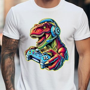 May include: A white t-shirt with a colorful graphic of a dinosaur wearing headphones and holding a video game controller.