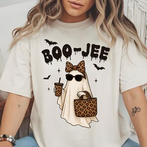 Halloween ghost wearing sunglasses, bow, and holding a purse
