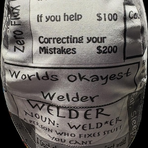 May include: A grey and white welding cap featuring printed text that reads: That was a Hourly Welding Rate, Min. $50, If you watch $75, If you help $100, Correcting your Mistakes $200, Worlds okayest Welder, WELDER NOUN: WELD*ER A PERSON WHO FIXES STUFF YOU CANT.
