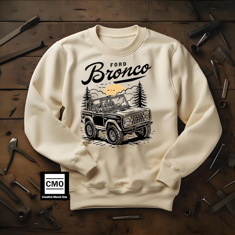 The Ford Bronco Adventure Sweatshirt exudes a sense of adventure and ruggedness, perfect for outdoor enthusiasts and fans of the iconic vehicle. This cozy sweatshirt is made with a medium-heavy fabric blend of 50% cotton and 50% polyester, providing