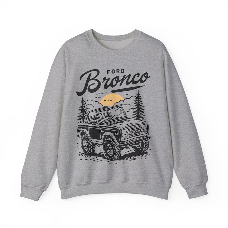 The Ford Bronco Adventure Sweatshirt exudes a sense of adventure and ruggedness, perfect for outdoor enthusiasts and fans of the iconic vehicle. This cozy sweatshirt is made with a medium-heavy fabric blend of 50% cotton and 50% polyester, providing