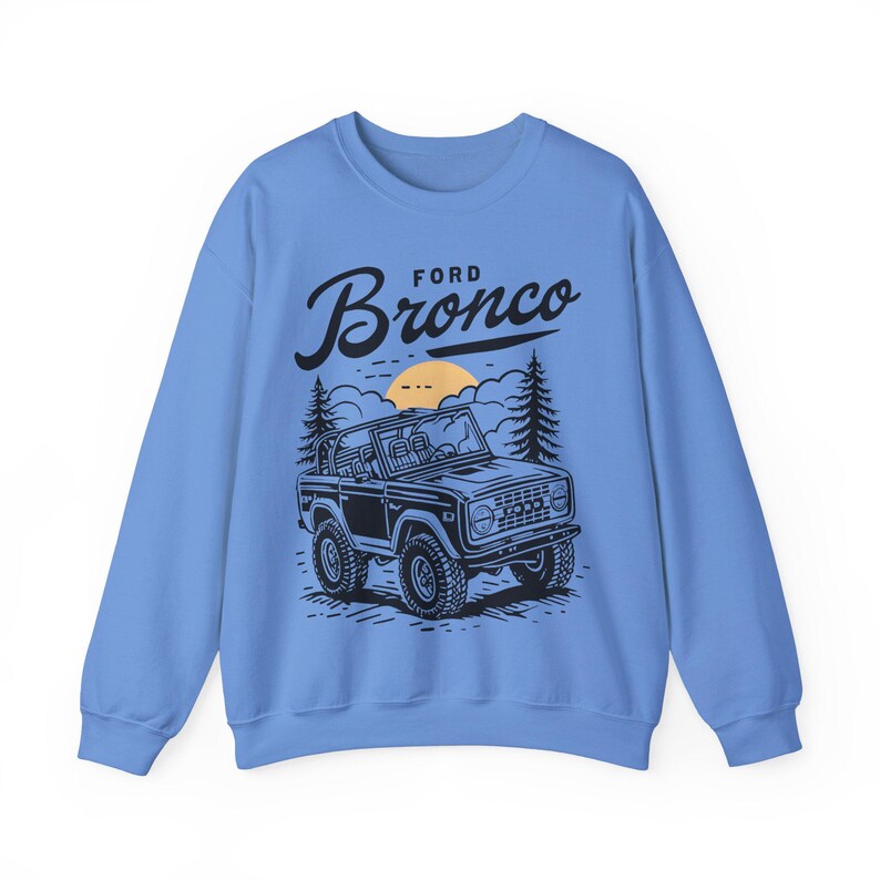 The Ford Bronco Adventure Sweatshirt exudes a sense of adventure and ruggedness, perfect for outdoor enthusiasts and fans of the iconic vehicle. This cozy sweatshirt is made with a medium-heavy fabric blend of 50% cotton and 50% polyester, providing