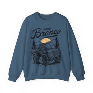 The Ford Bronco Adventure Sweatshirt exudes a sense of adventure and ruggedness, perfect for outdoor enthusiasts and fans of the iconic vehicle. This cozy sweatshirt is made with a medium-heavy fabric blend of 50% cotton and 50% polyester, providing
