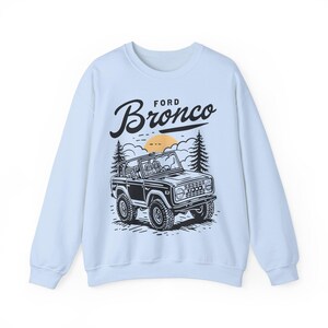 The Ford Bronco Adventure Sweatshirt exudes a sense of adventure and ruggedness, perfect for outdoor enthusiasts and fans of the iconic vehicle. This cozy sweatshirt is made with a medium-heavy fabric blend of 50% cotton and 50% polyester, providing