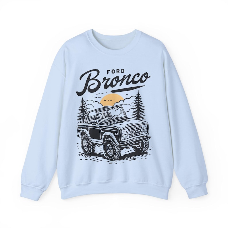 The Ford Bronco Adventure Sweatshirt exudes a sense of adventure and ruggedness, perfect for outdoor enthusiasts and fans of the iconic vehicle. This cozy sweatshirt is made with a medium-heavy fabric blend of 50% cotton and 50% polyester, providing